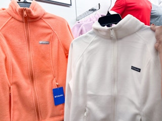 two columbia full-zip jackets hanging on a rack