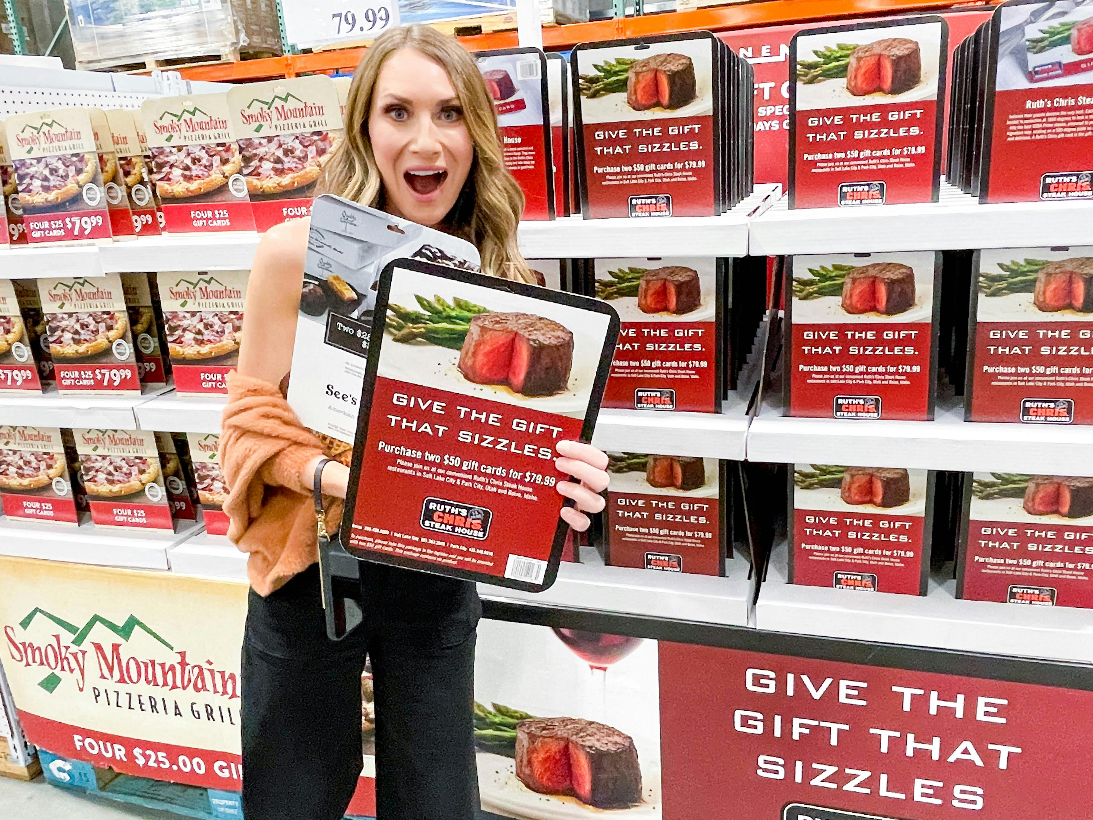 a woman holding giftcards in costco 