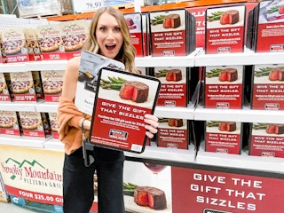 a woman holding giftcards in costco 