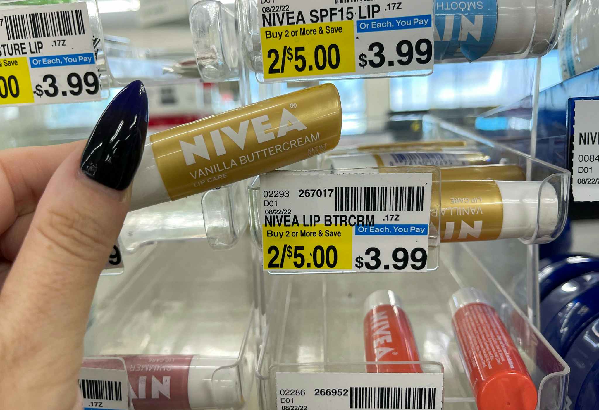 hand holding nivea lip balm next to price