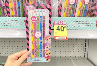 hand holding pens next to clearance tag
