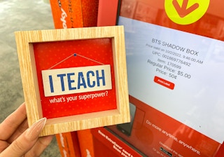 hand holding shadow box next to coupon center