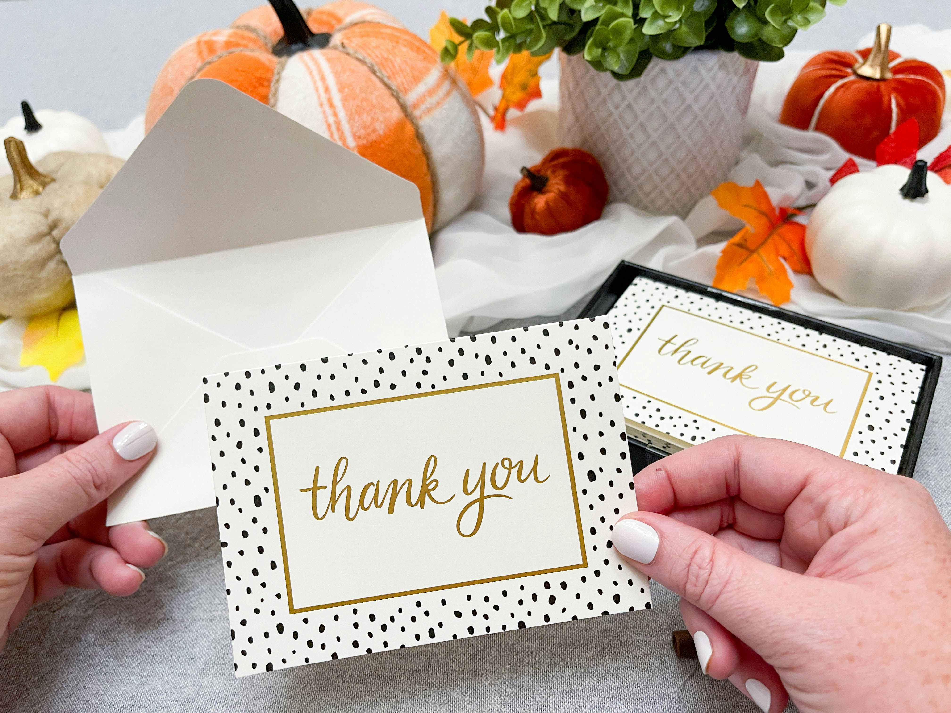 thank you note being held and about to be put into an envelope
