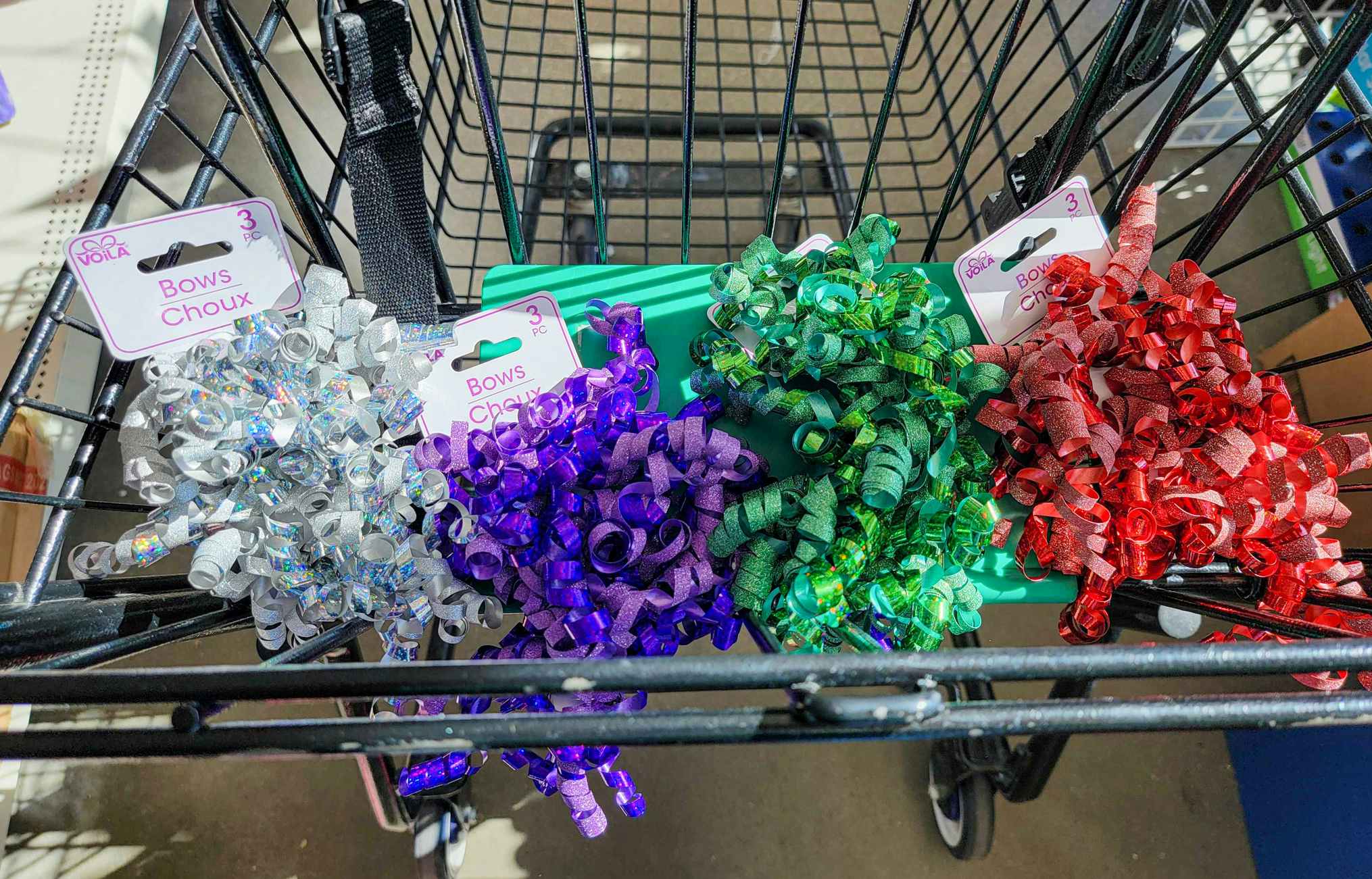 silver, purple, green, and red bows in a cart