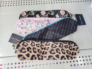 4 designs of kendall and kylie cosmetic bags on a shelf