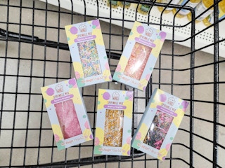 5 packs of sprinkles in a cart