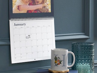 calendar on blue wall with date circled for booking flights