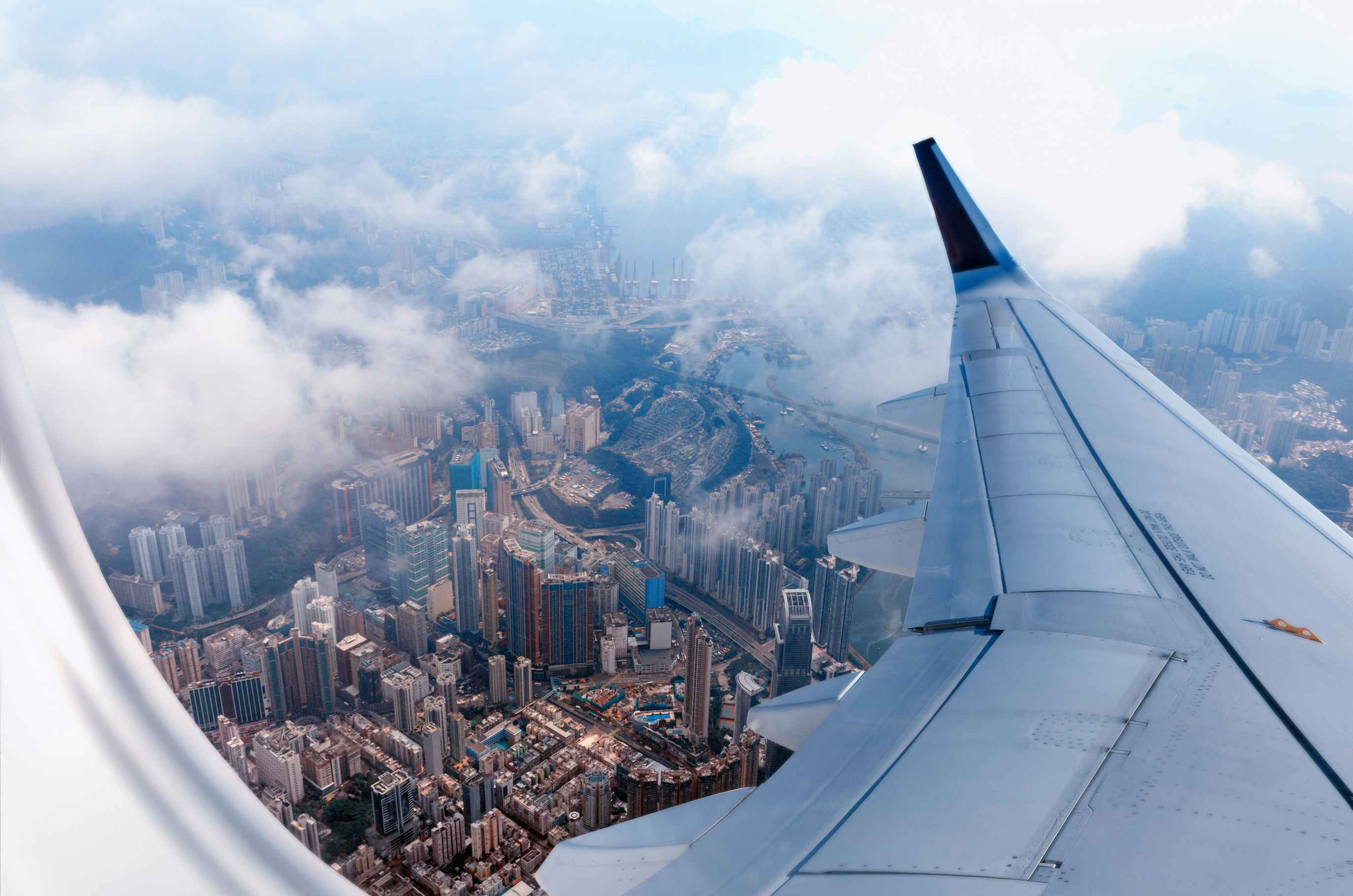 An aerial view of Hong Kong from an airplane window.