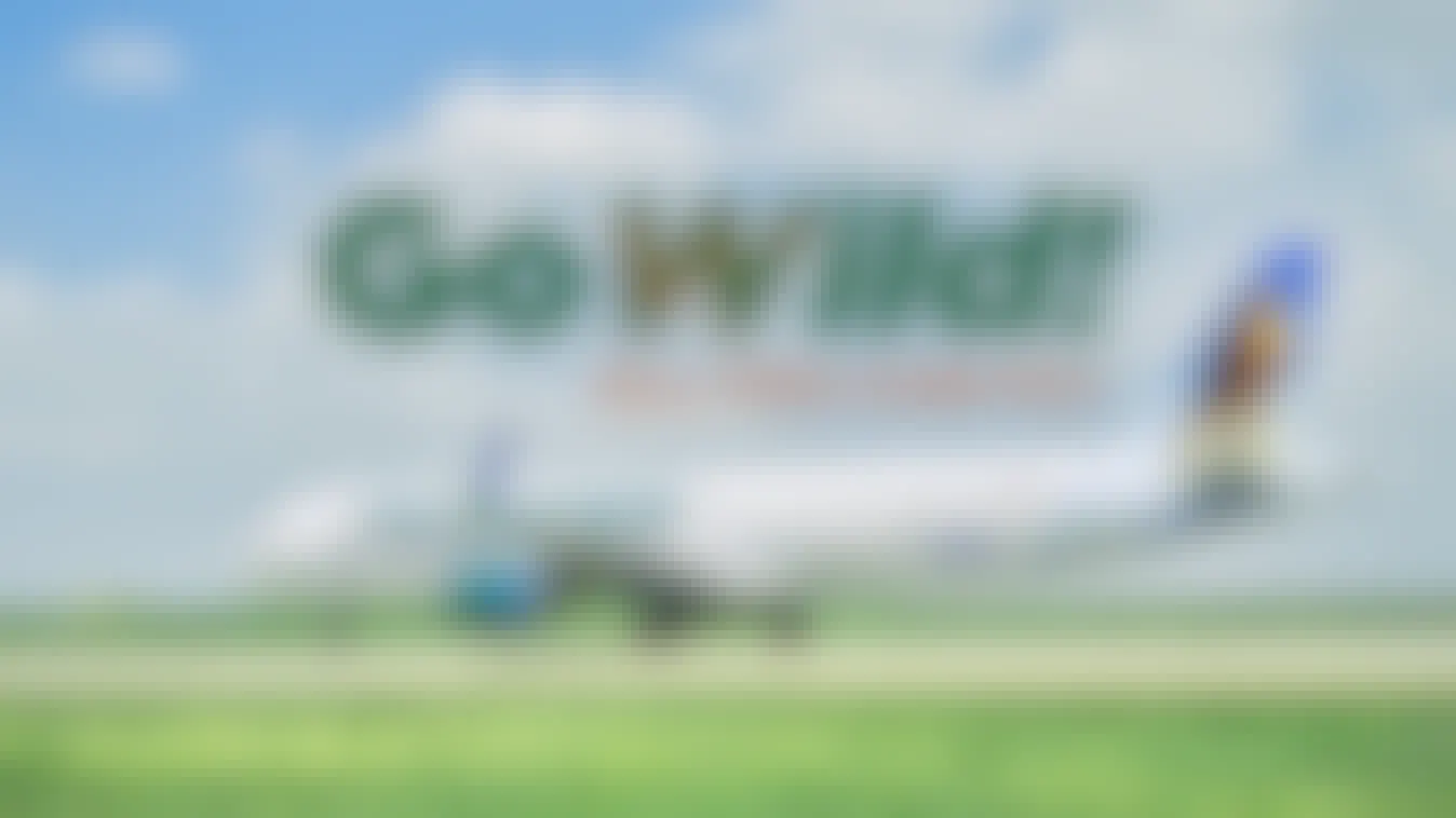 A Frontier Airlines plane on a tarmac with the GoWild All-You-Can-Fly pass logo above it