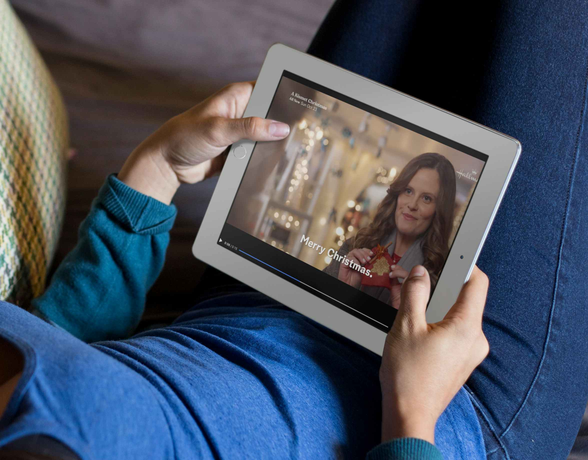 Mockup of a woman watching Hallmark christmas movies on the couch on an ipad