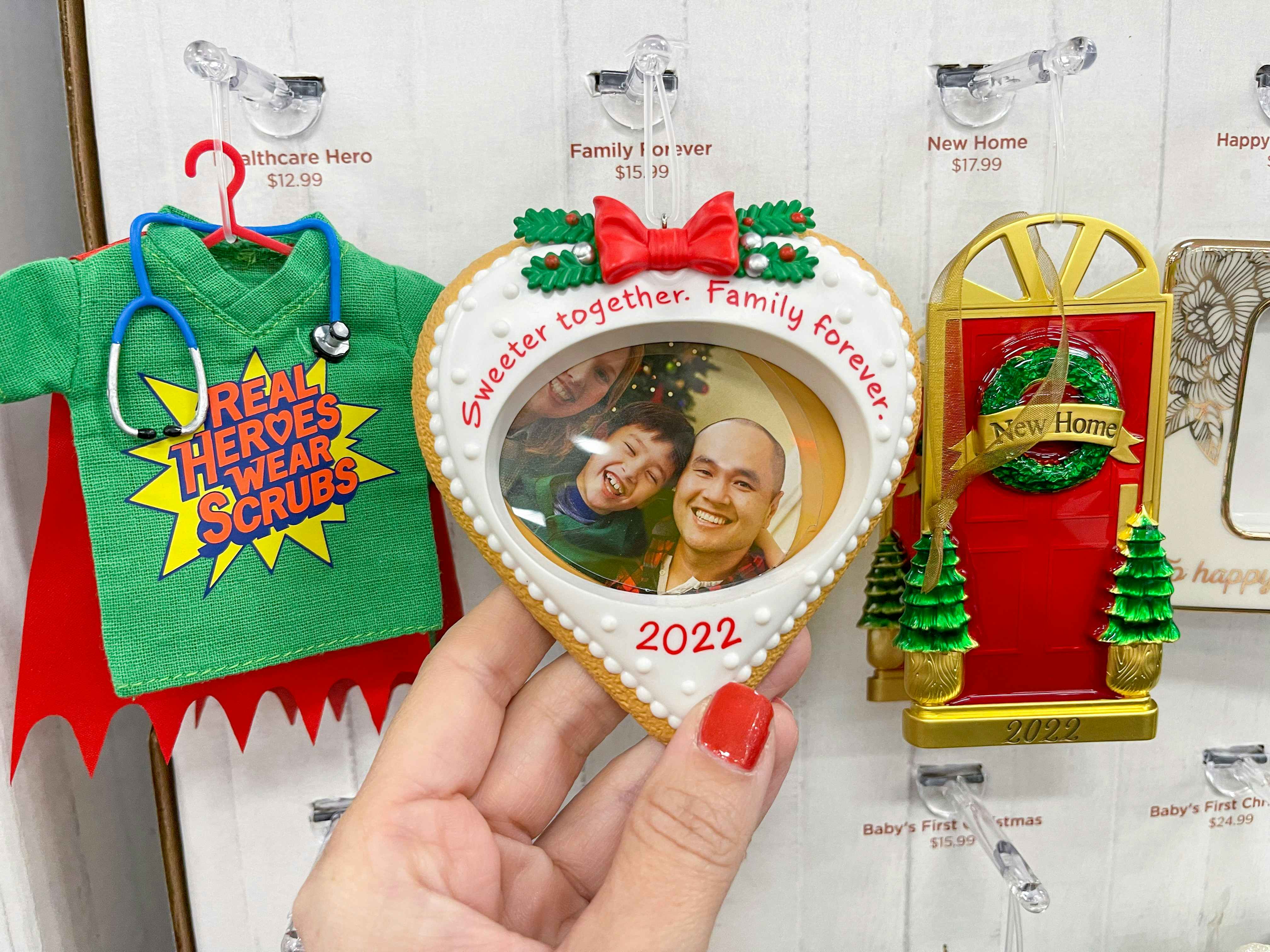 A Hallmark ornament held while hanging from display