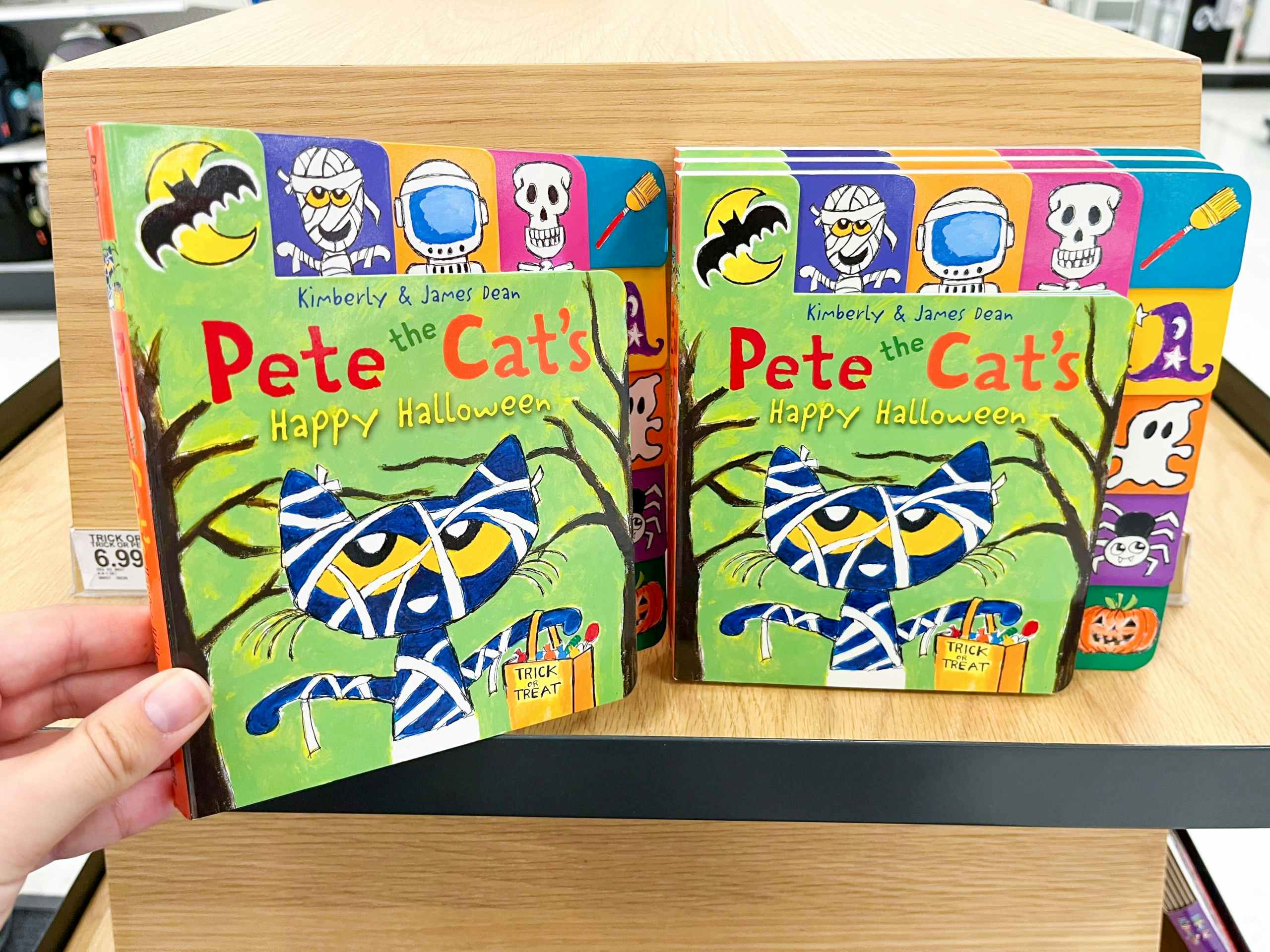 hand holding pete the cat halloween book