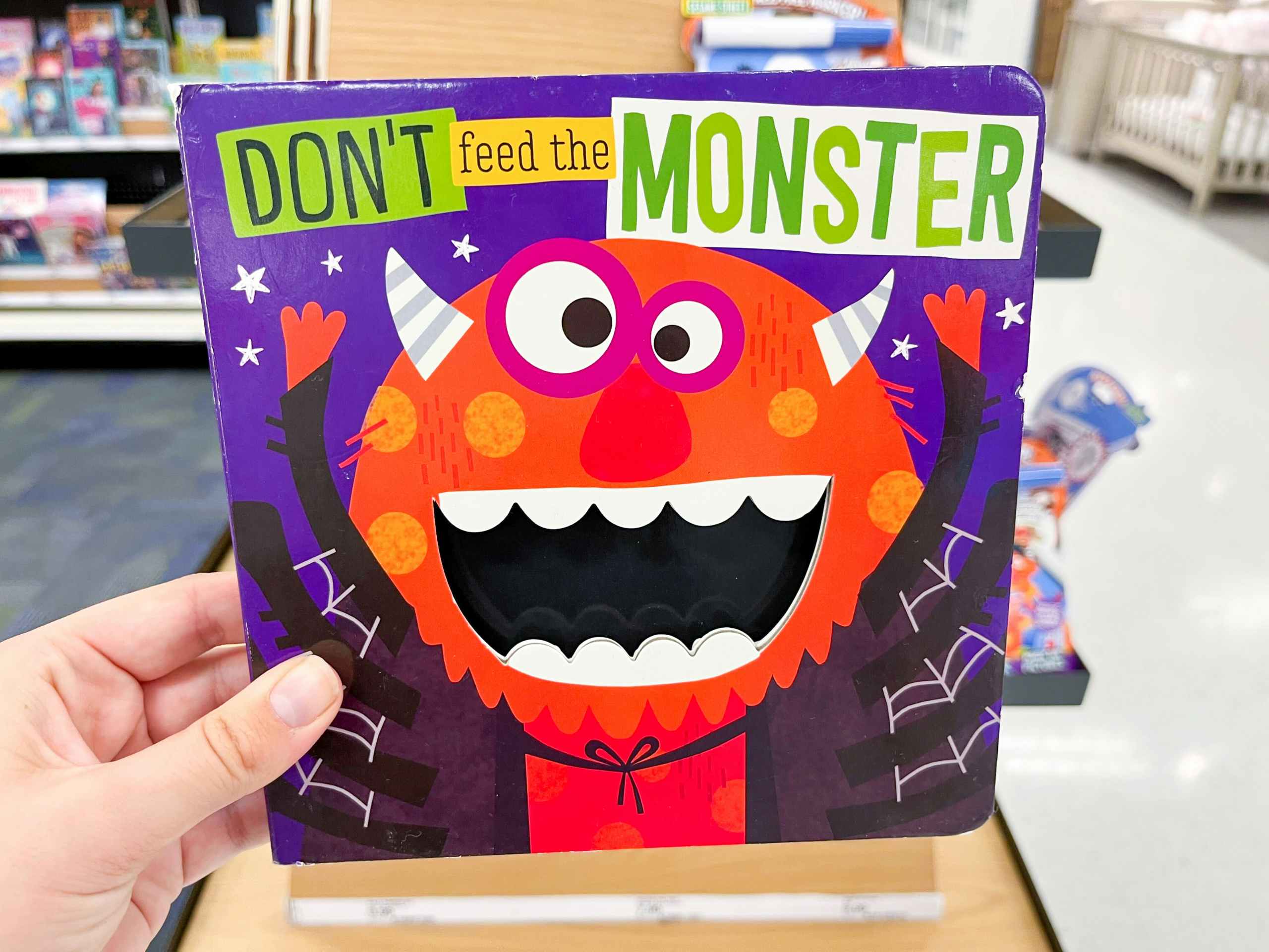 hand holding monster picture book