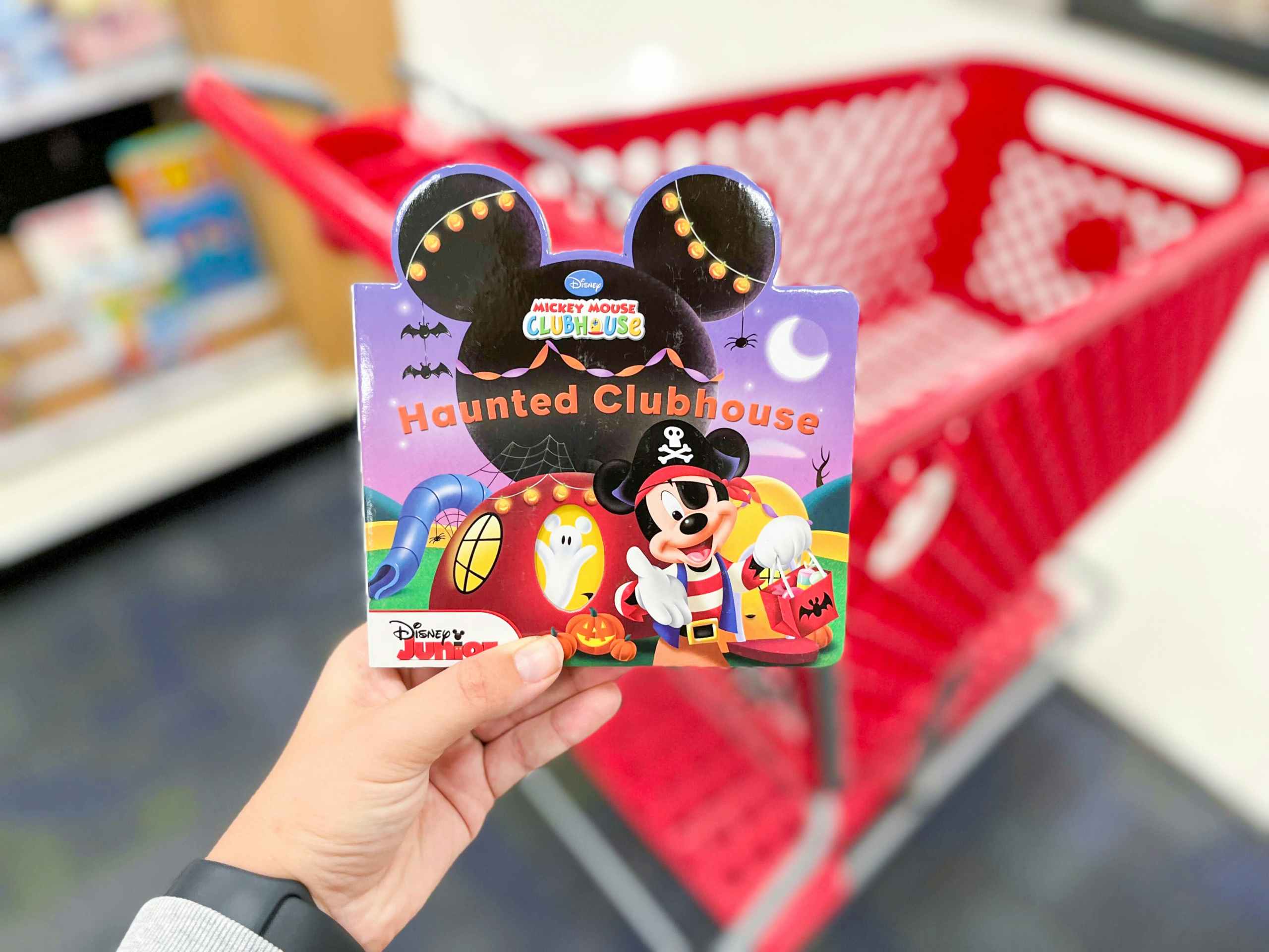 hand holding mickey mouse halloween book