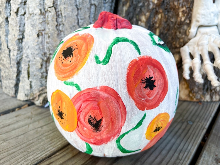 Colorful flowers painted on a pumpkin.