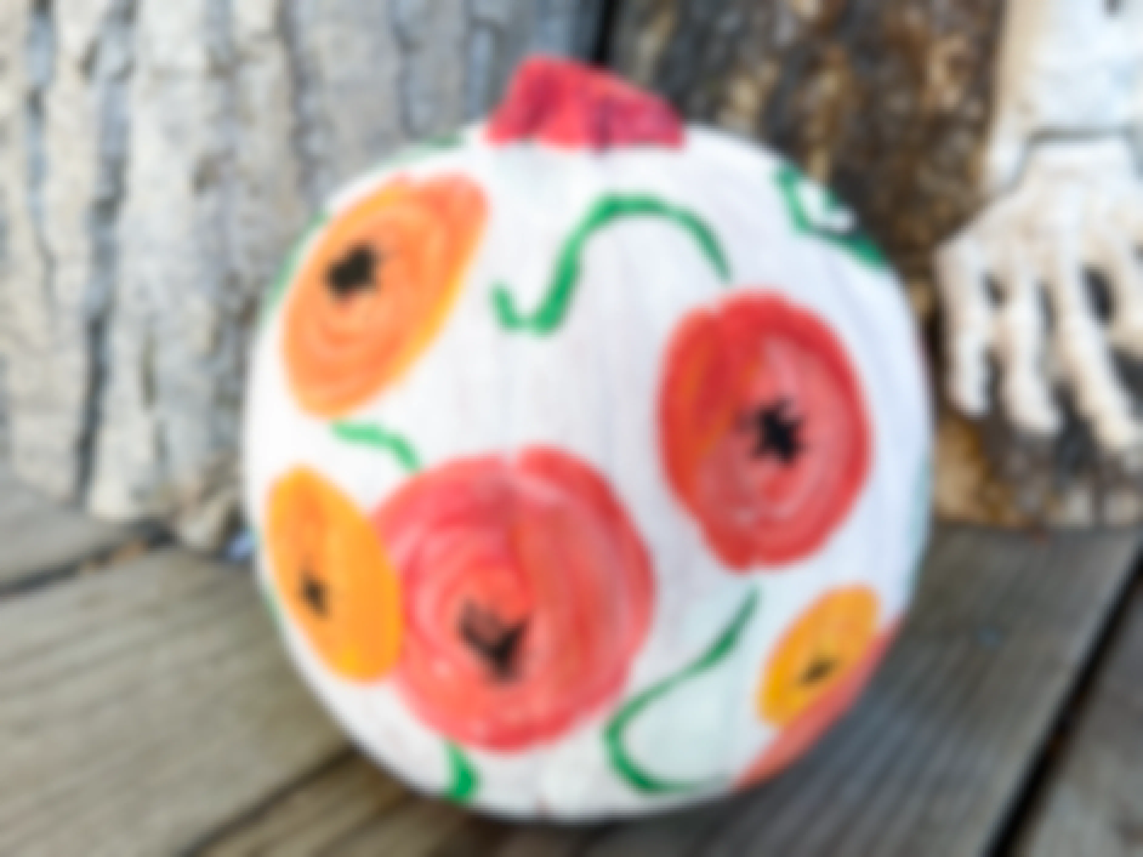 Colorful flowers painted on a pumpkin.