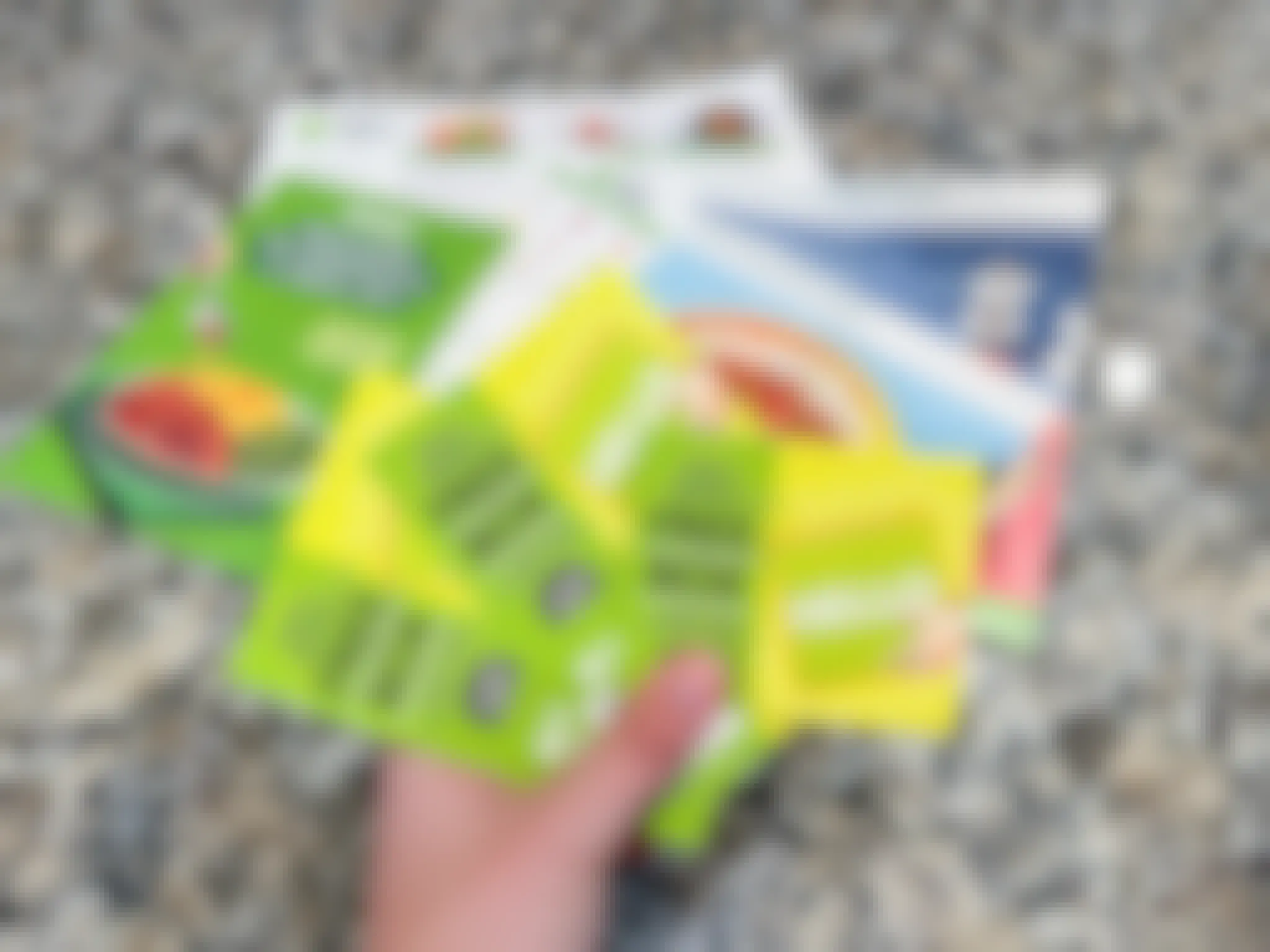 Someone holding up some Hello Fresh cards for Free Boxes to give to friends