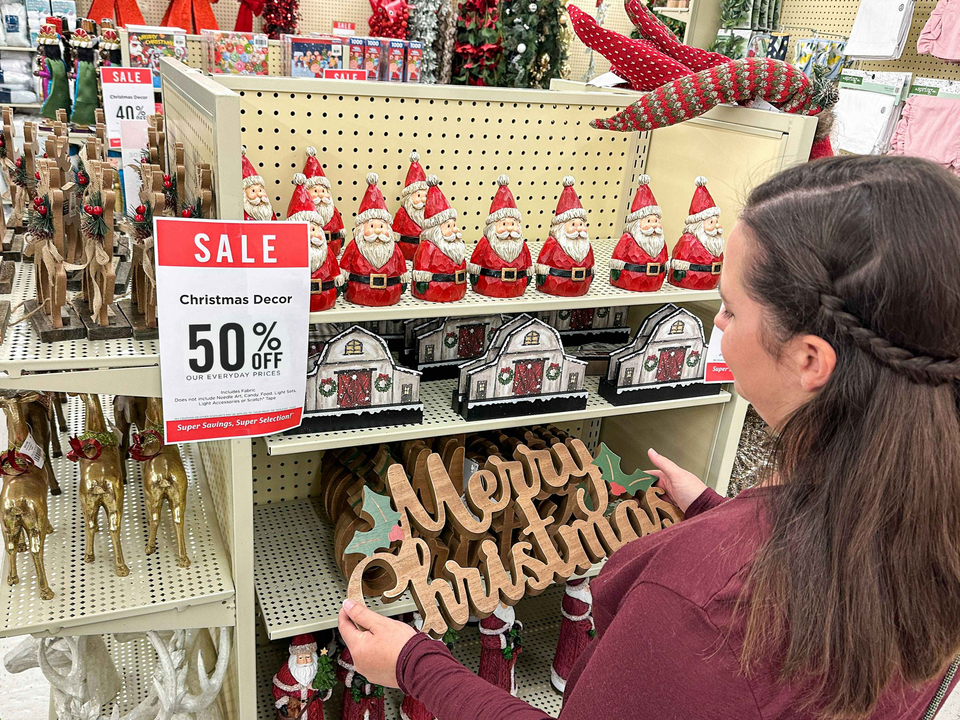 a person shopping 50 percent off christmas decor in hobby lobby