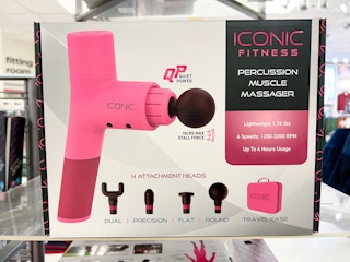 a pink massage gun in its box