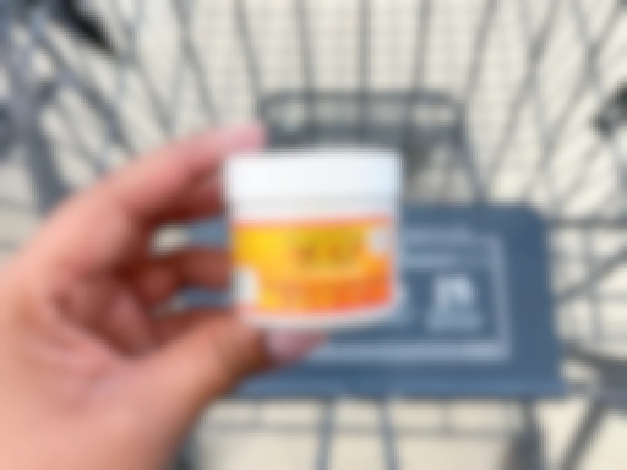 hand holding container of cantu curling cream