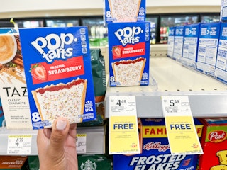 hand holding pop tarts next to price signage