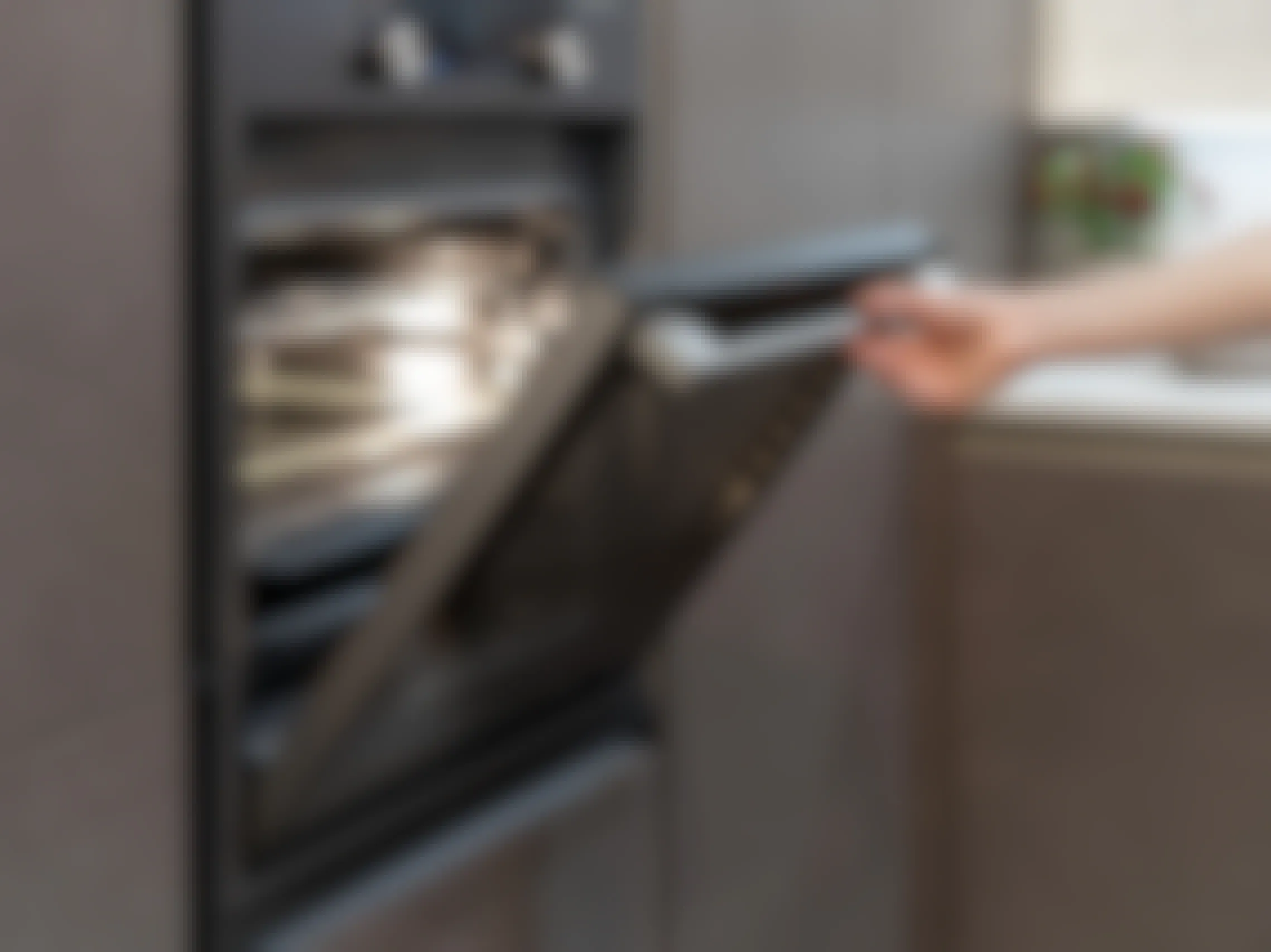 A person opening the door of their electric oven