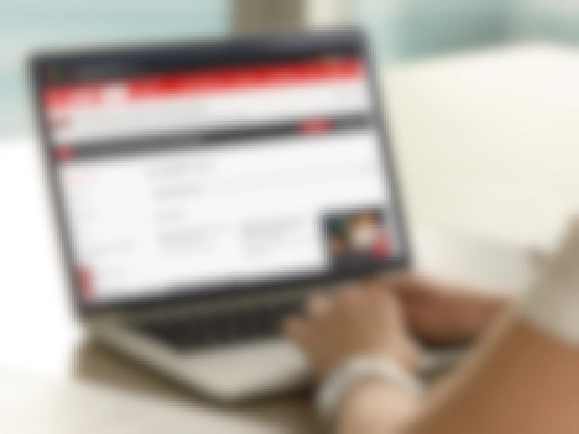A person using a laptop displaying the AARP website's Member Benefits