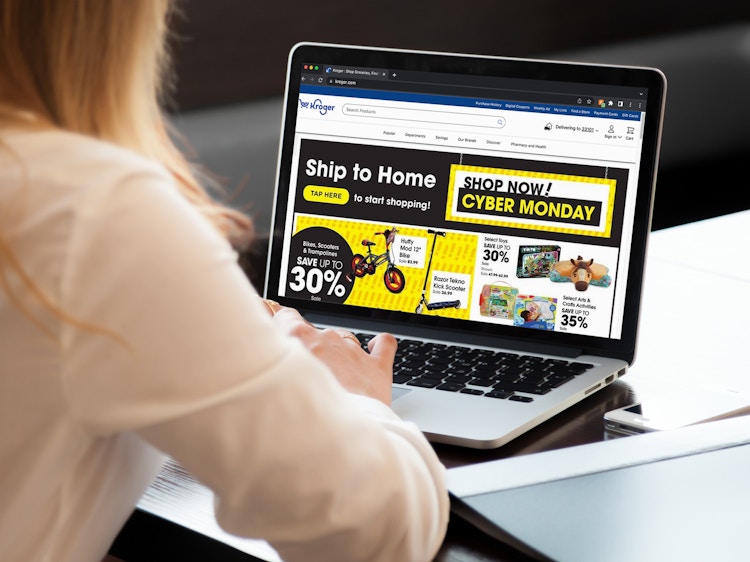 A person looking at the Kroger Cyber Monday ad on a laptop