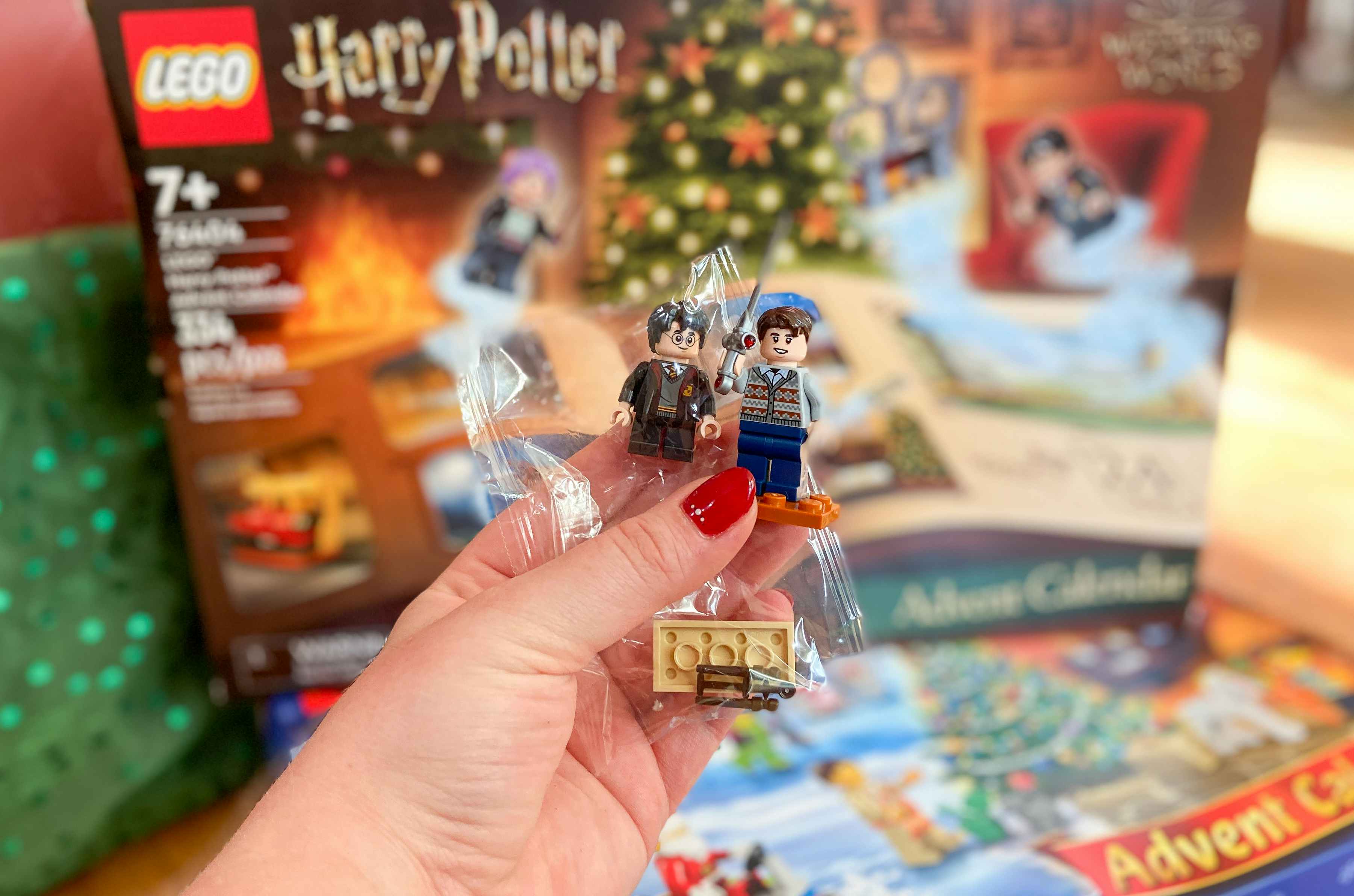 hand holding pieces of the lego harry potter advent calendar