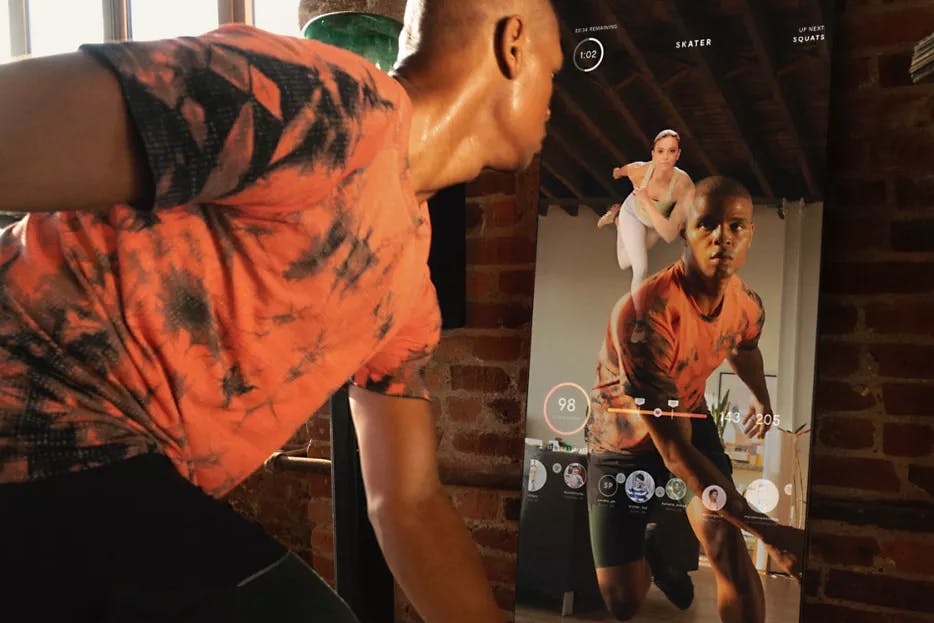 A person working out in front of a Lululemon Studio Mirror