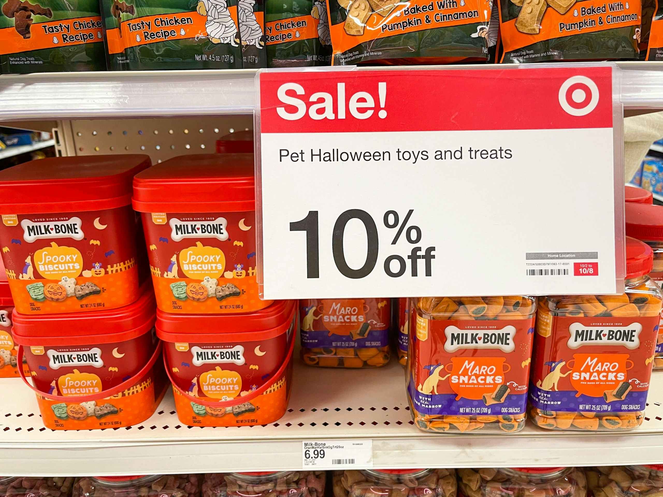 sale sign in front of dog treat shelf