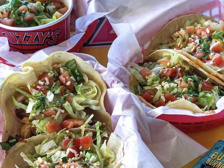 a group of tacos from Fuzzy's on a table... these tacos are available on national taco day