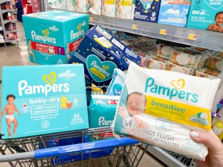 a cart filled with boxes of pampers diapers and wipes being held