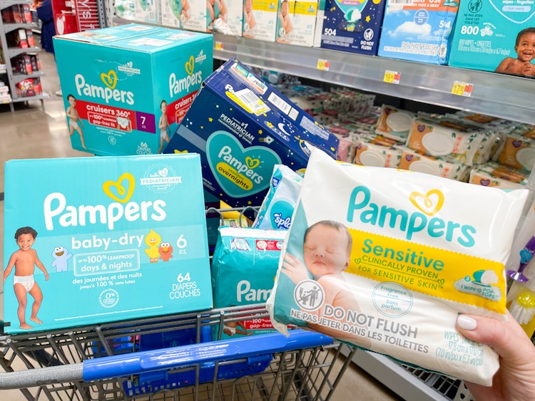 a cart filled with boxes of pampers diapers and wipes being held