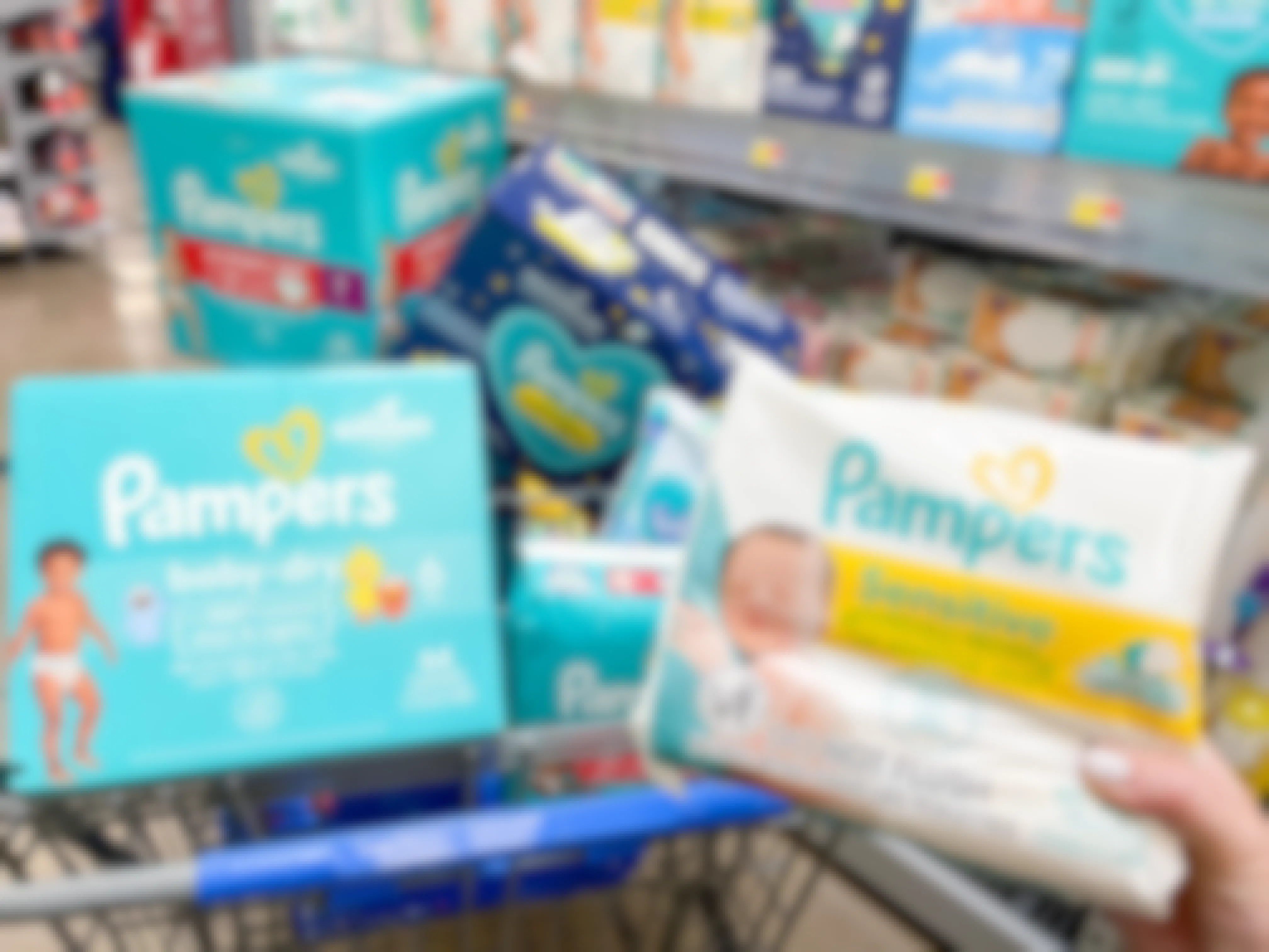 a cart filled with boxes of pampers diapers and wipes being held