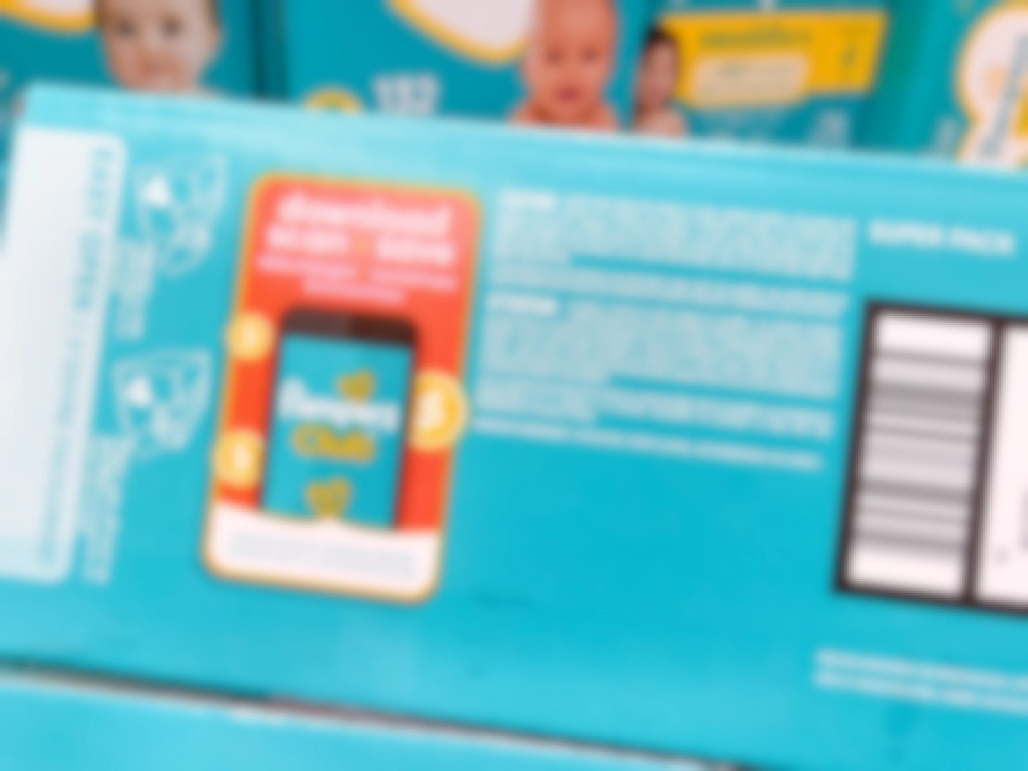 a box of pampers with the scan and save club info on box