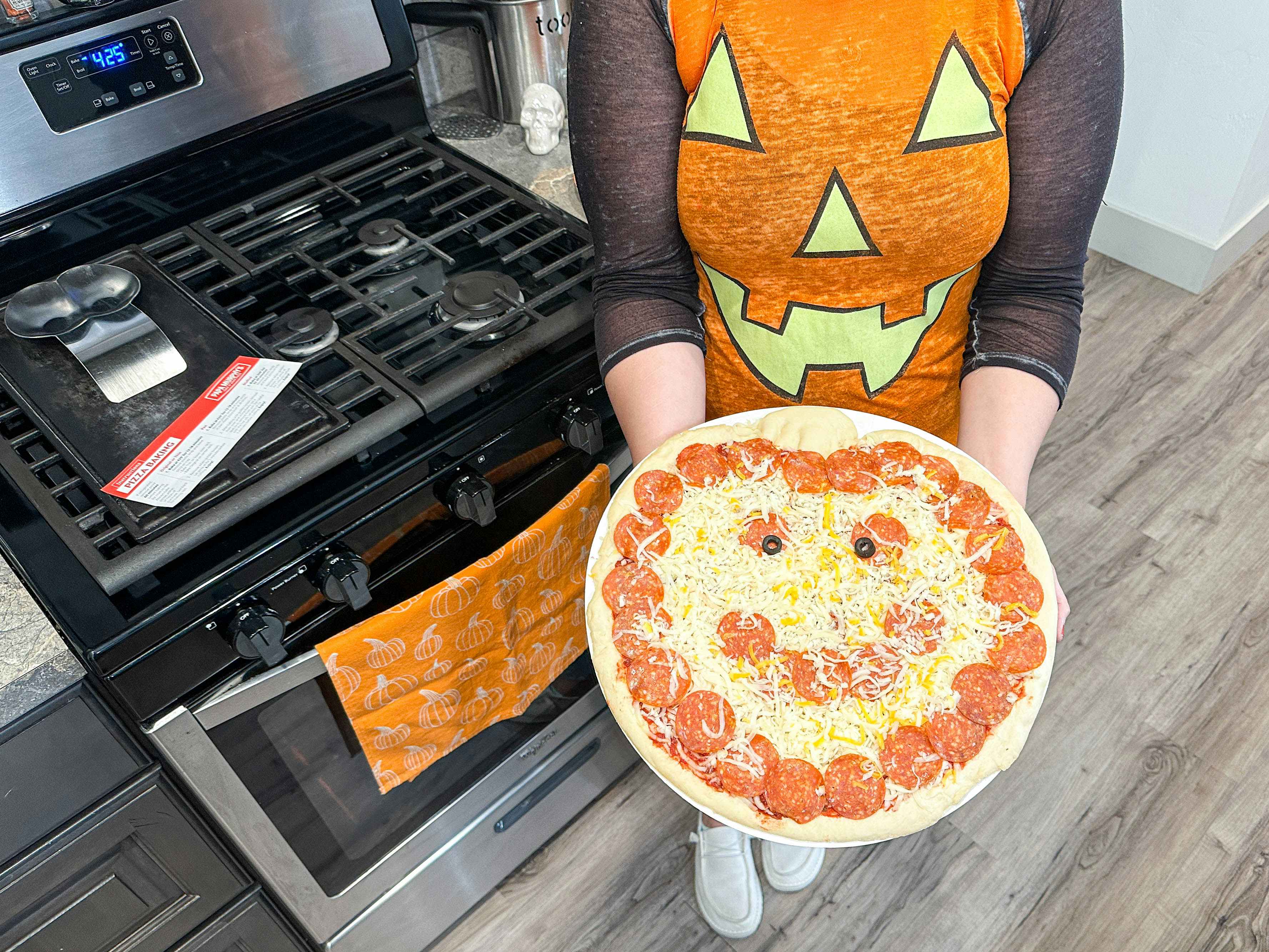 a person holding a papa murphys halloween pizza