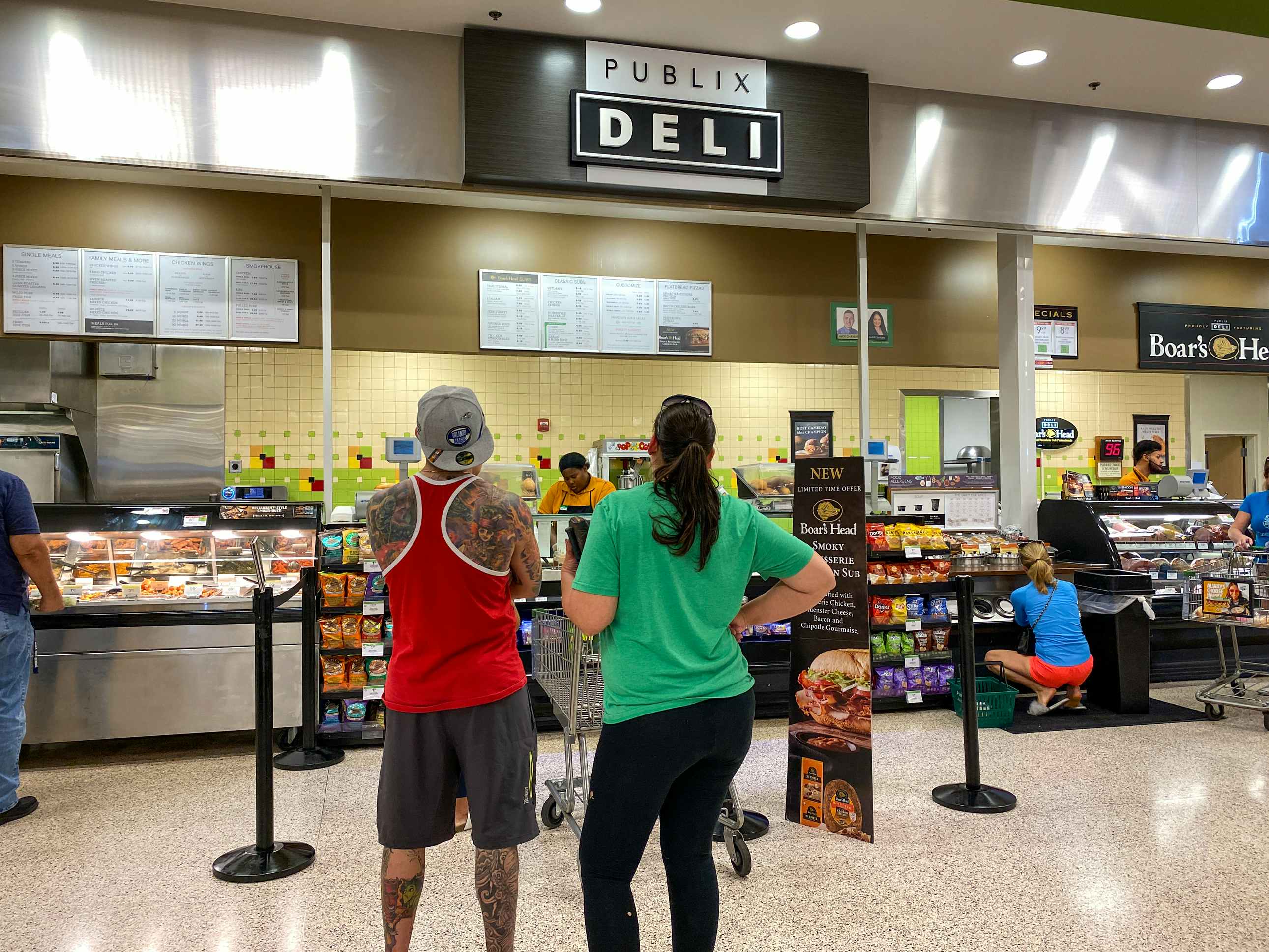 People standing in line at the Publix deli counter