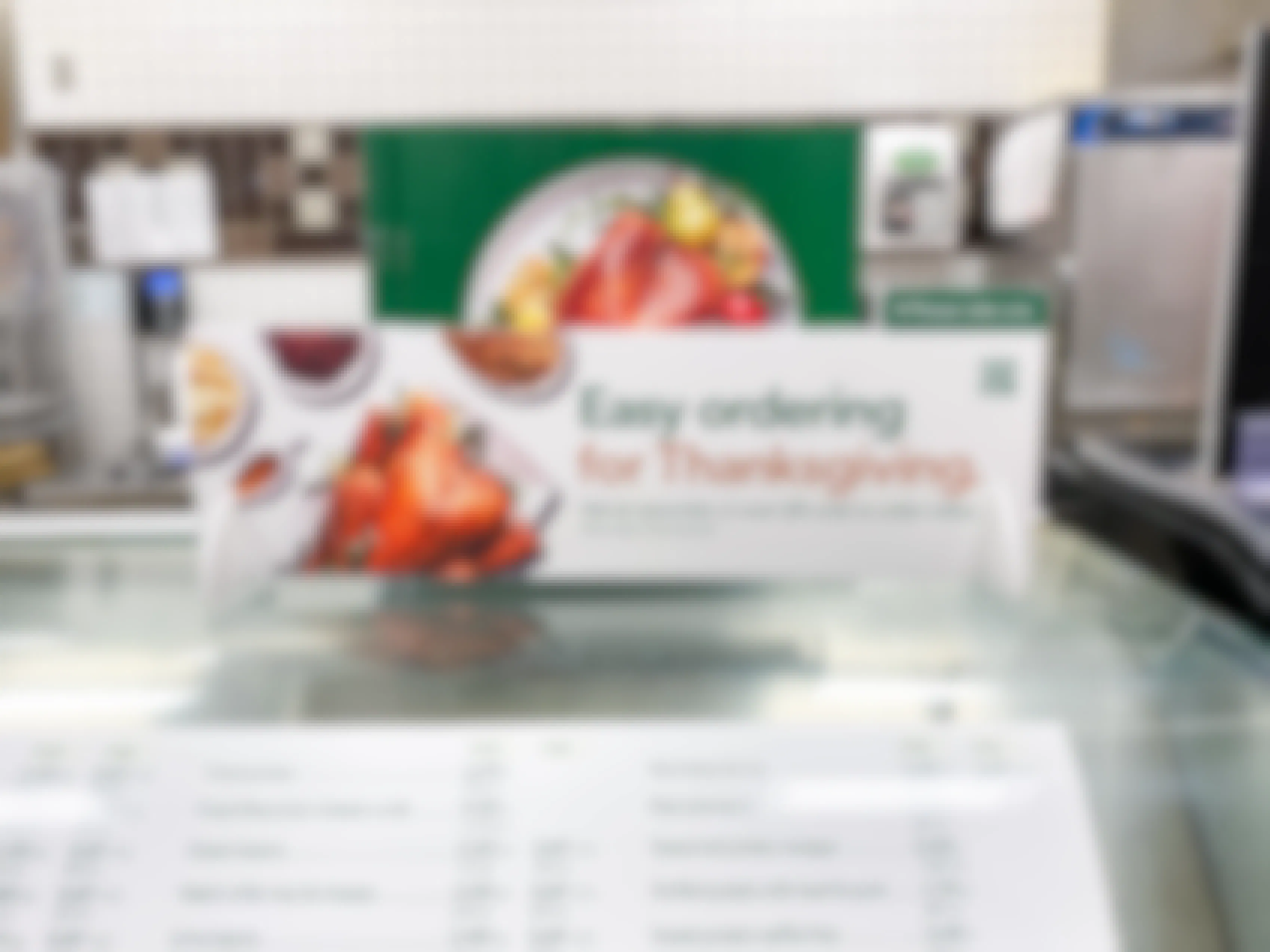 A sign in the Publix Deli that says, "Easy ordering for Thanksgiving" with some booklets to take.