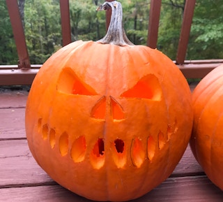 a pumpkin carved with a scary face