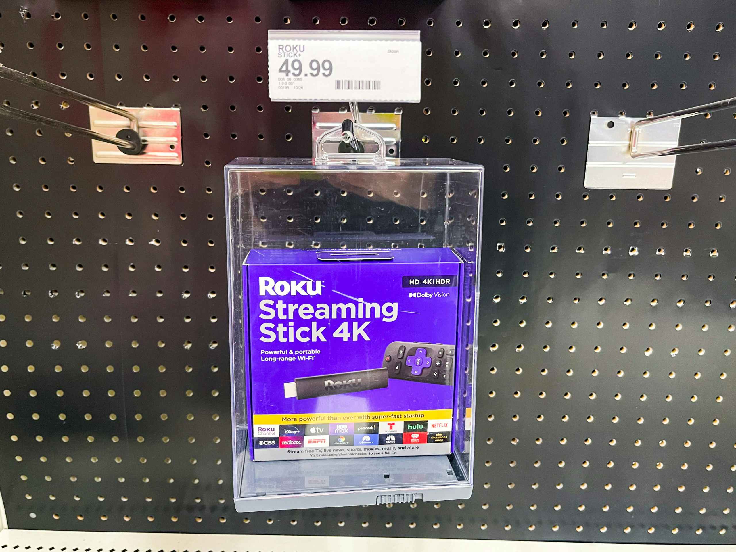 A Roku Streaming Stick 4K hanging from shelf.