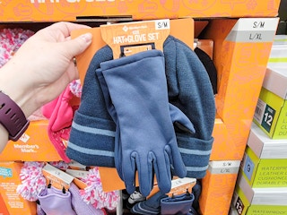 hand holding a blue kids hat & glove set