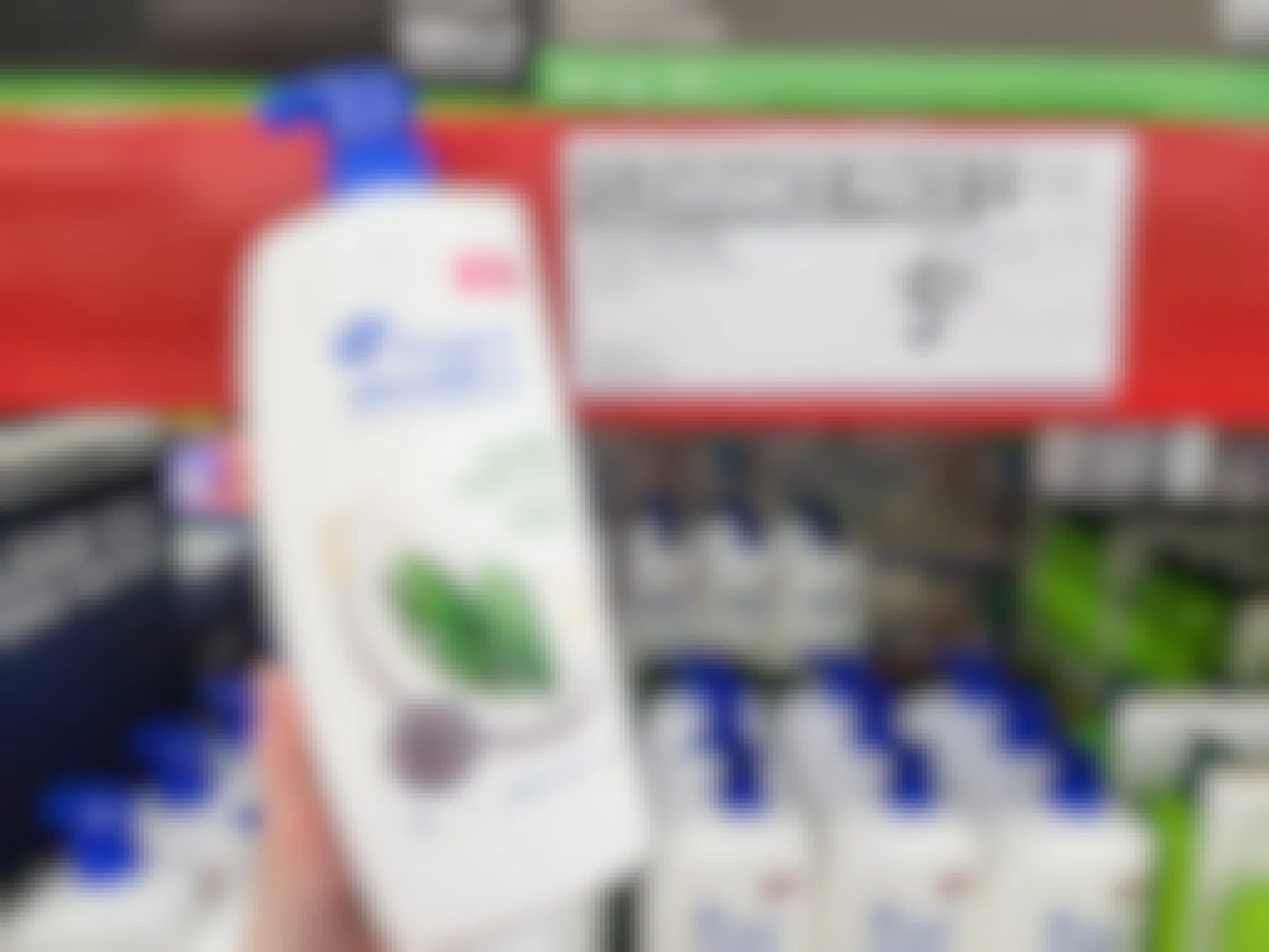 hand holding a bottle of head & shoulders by a sign for 5.81