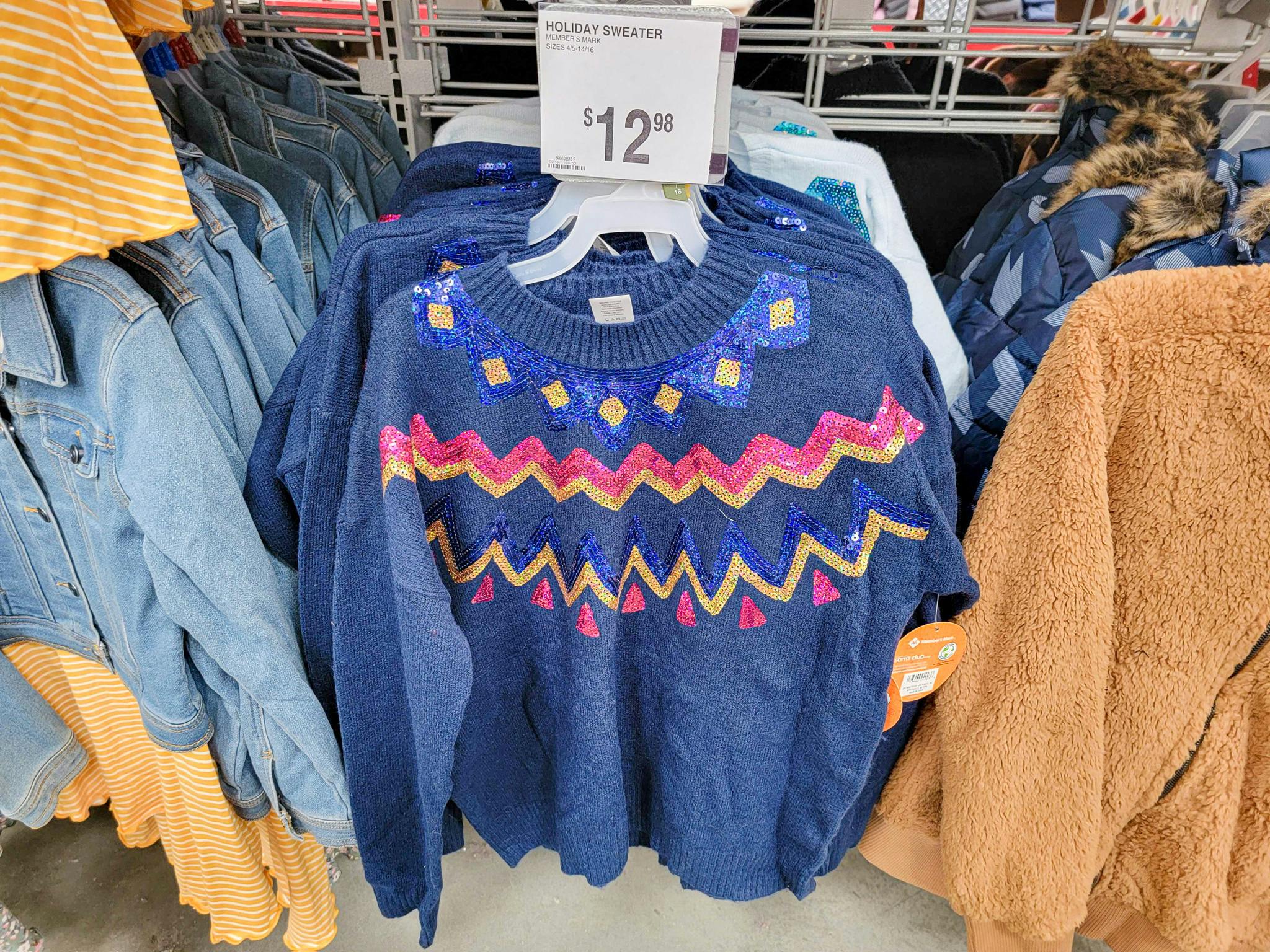 blue sweater with pink & yellow zig zags