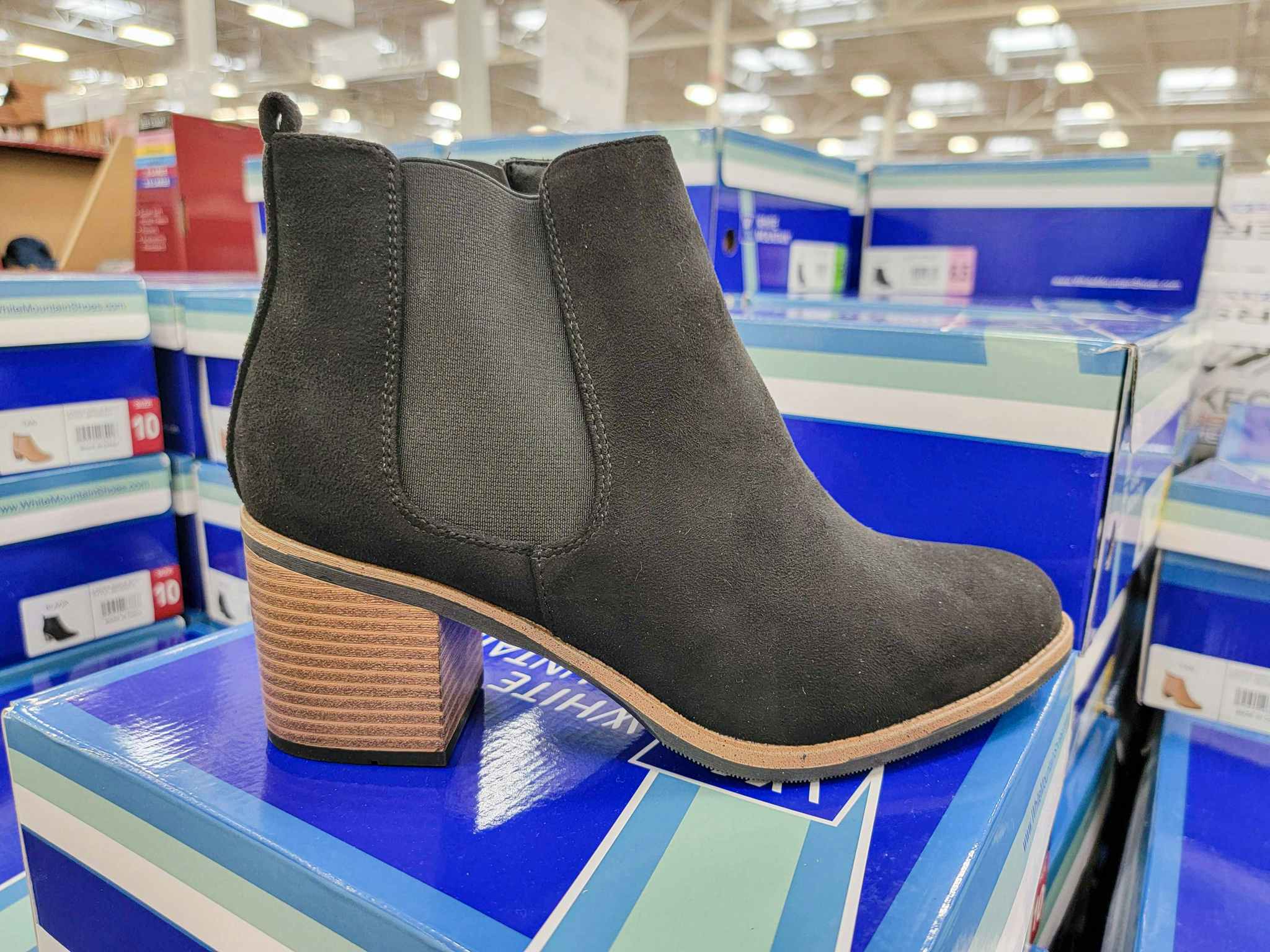 black heeled ankle bootie on a box