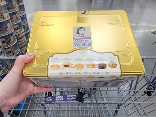 a tin of pastry cookies in a cart