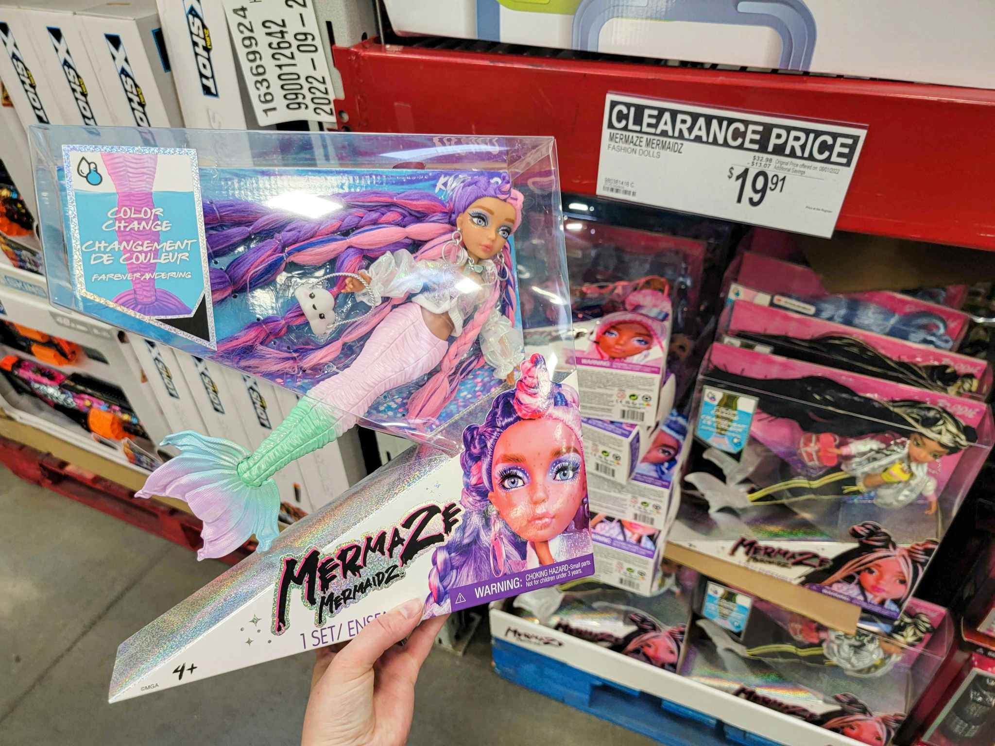hand holding a mermaidz doll by the 19.91 clearance sign