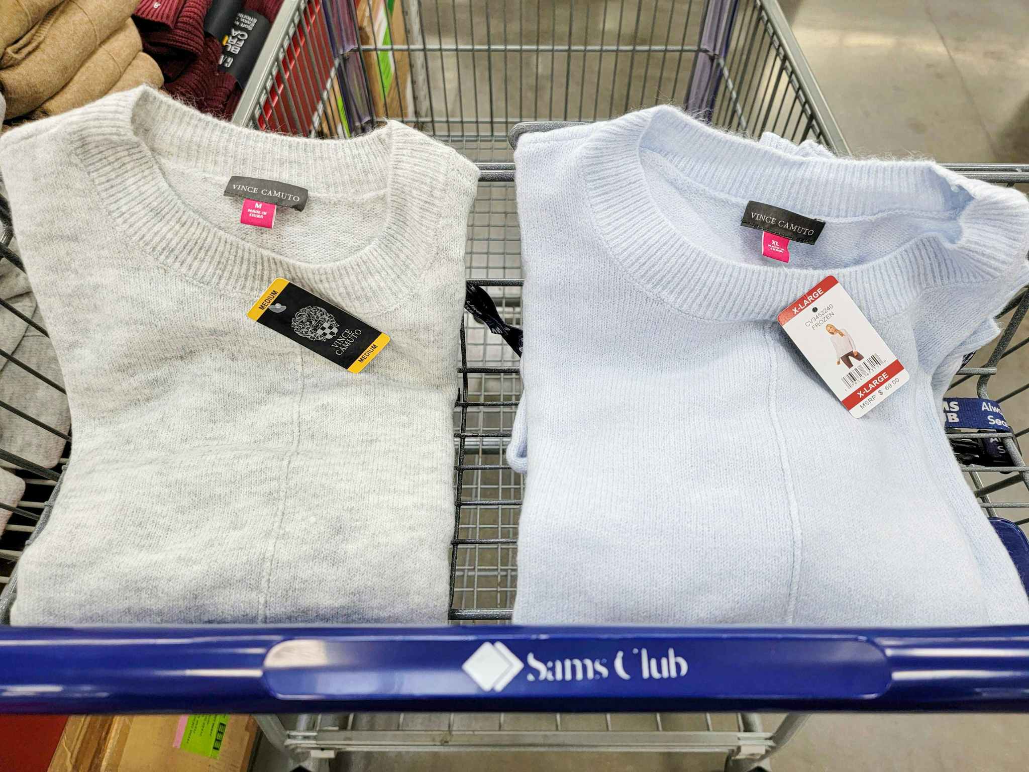 grey and light blue sweaters in a cart