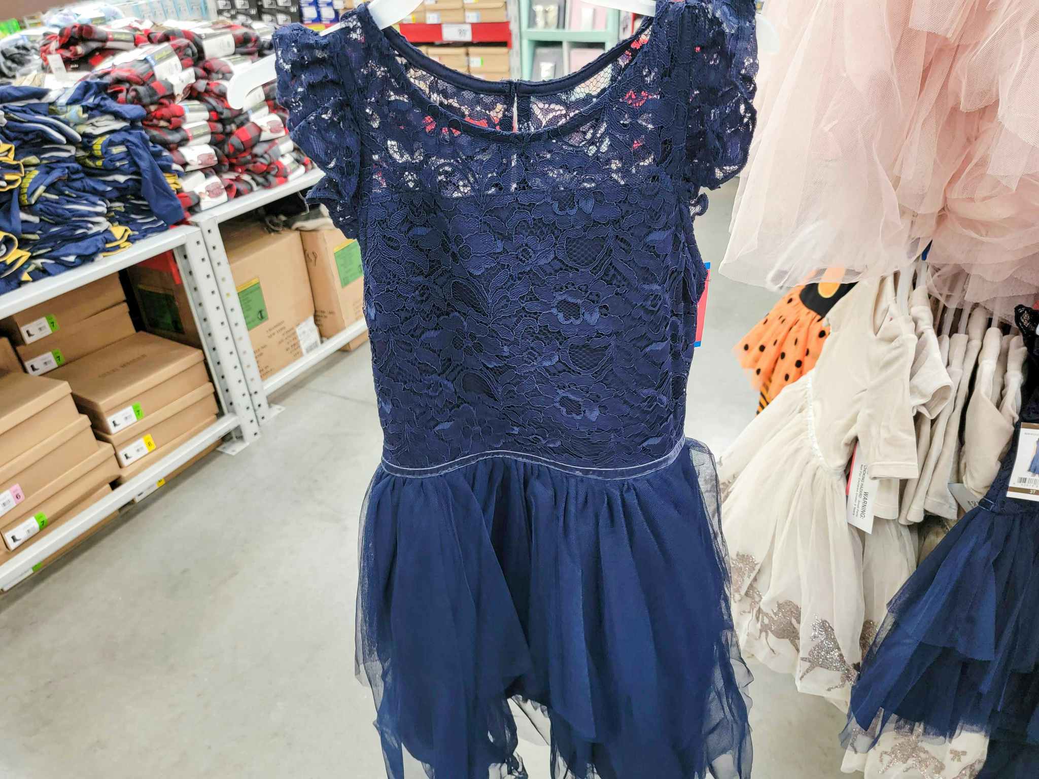 a navy blue kids dress with a lace top