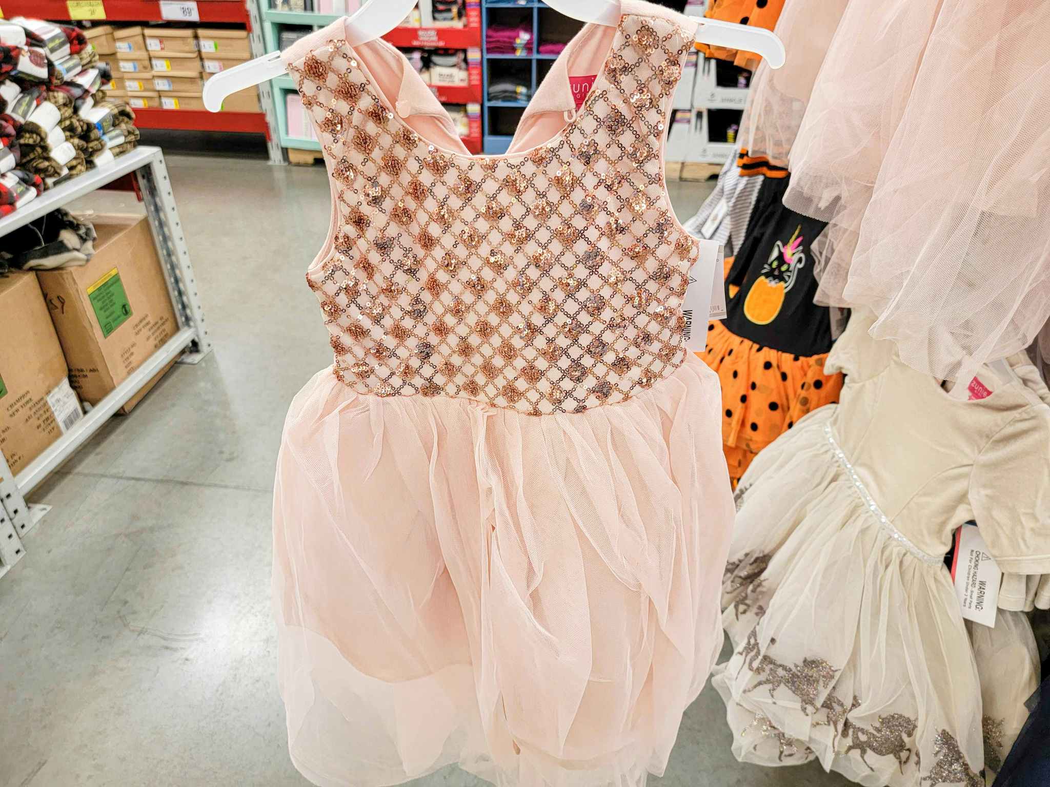 a peach kids dress with sequins on top